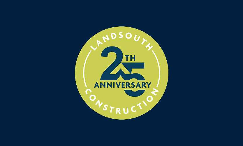 A green circular badge with “LandSouth Construction” and “25th Anniversary” written in dark blue on a dark blue background, celebrating their legacy as leaders in multifamily construction.