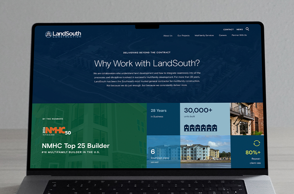 A laptop displays the LandSouth Construction website featuring company statistics, accolades, and a section titled “Why Work with LandSouth?” in white text on a blue background.